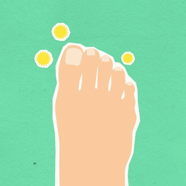 Person at a home desk experiencing foot discomfort while working remotely