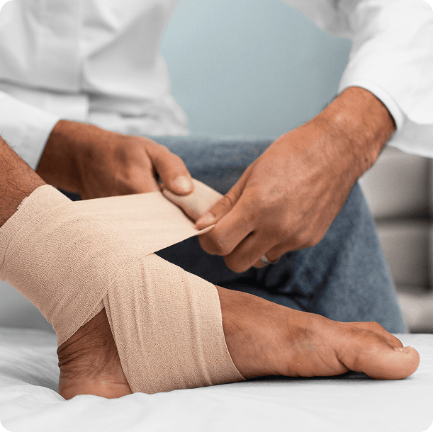 Healthcare provider wrapping a compression bandage on a patient's foot and ankle